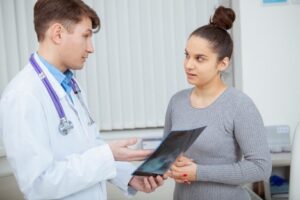 A male doctor is speaking to his female patient about the results of her barium X-ray. The patient asked the doctor, What are the common conditions that affect the esophagus?