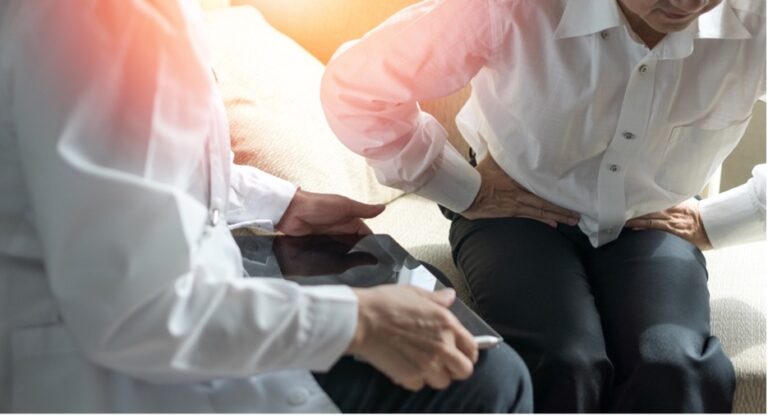 A doctor giving a patient a diagnosis for Crohn’s disease